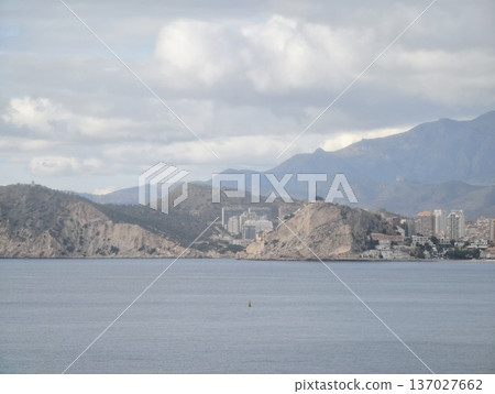 Serene hilltop view of city, Peaceful promontory overlooking distant shorelines and mountains Serene hilltop view of city, Peaceful promontory overlooking distant shorelines and mountains 137027662