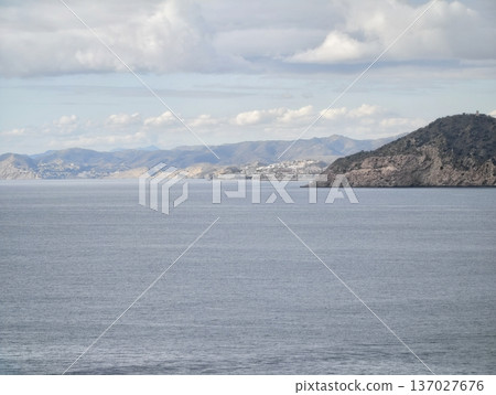 Peaceful sea scenery, Serene ocean view with hills, Calm waters blending with distant shores and gentle hills Peaceful sea scenery, Serene ocean view with hills, Calm waters blending with distant shores and gentle hills 137027676