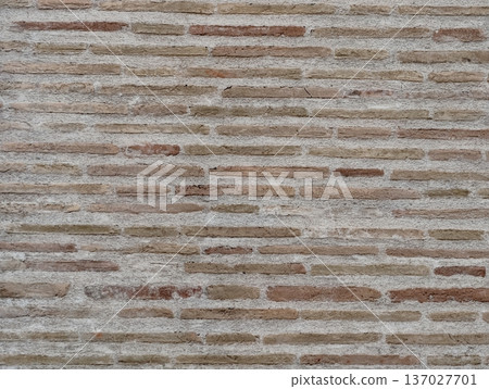 Subtle textured brick wall featuring gentle beige hues and precise horizontal layer alignment 137027701