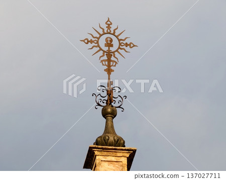 Sunlit bronze architectural detail, Ornamental bronze finial and ironwork captured in morning light 137027711
