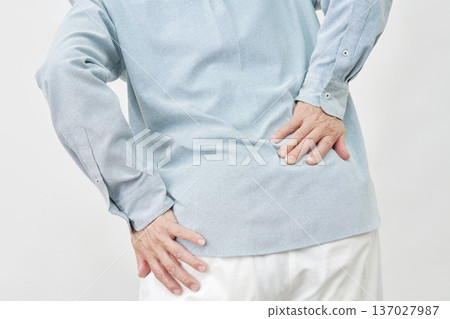 Man holding his waist against white background, no face Man holding his waist against white background, no face 137027987