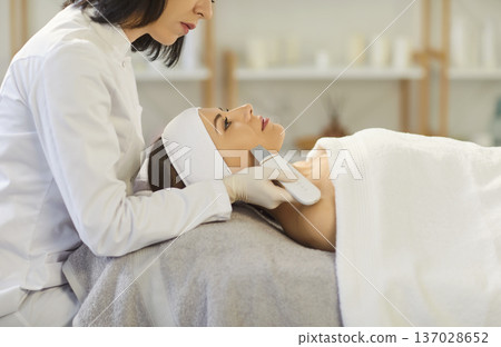 Facial treatment done by esthetician using ultrasonic device in modern spa clinic 137028652