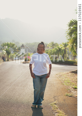 Smiling Mature Scandinavian Tourist Woman Walking Outdoors on Summer Holiday Smiling Mature Scandinavian Tourist Woman Walking Outdoors on Summer Holiday 137028981