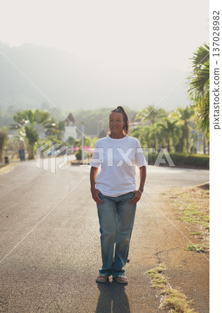 Smiling Mature Scandinavian Tourist Woman Walking Outdoors on Summer Holiday Smiling Mature Scandinavian Tourist Woman Walking Outdoors on Summer Holiday 137028982