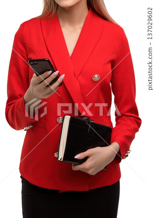Professional woman in red blazer holding phone and wallet Professional woman in red blazer holding phone and wallet 137029602