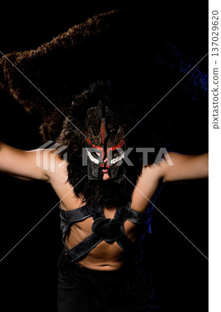 Cultural performer showcases traditional mask dance during nighttime event 137029620