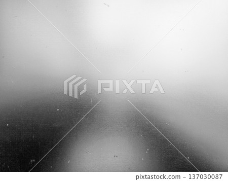 Grainy black and white glass window with abstract light 137030087