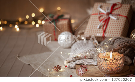 Christmas background with decorative burning candle and decor details on the backdrop. Christmas background with decorative burning candle and decor details on the backdrop. 137030207