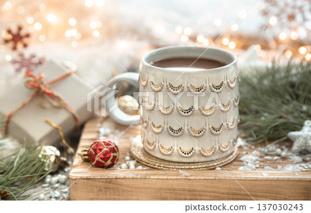 Christmas composition with a cup of coffee on a blurred background. Christmas composition with a cup of coffee on a blurred background. 137030243