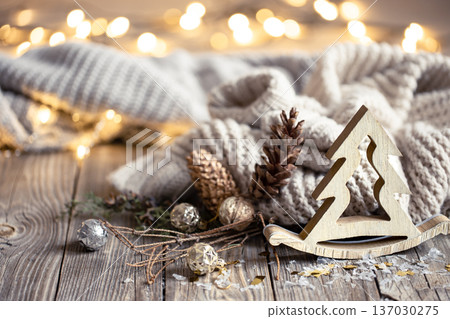Christmas composition with wooden decorative element on blurred background. Christmas composition with wooden decorative element on blurred background. 137030275