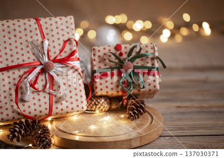 Christmas gifts in beautiful wrapping paper on a blurred background. Christmas gifts in beautiful wrapping paper on a blurred background. 137030371