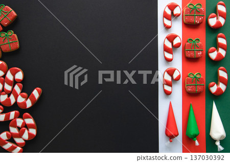 Christmas handmade gingerbread cookies covered with colorful icing, flat lay. Christmas handmade gingerbread cookies covered with colorful icing, flat lay. 137030392