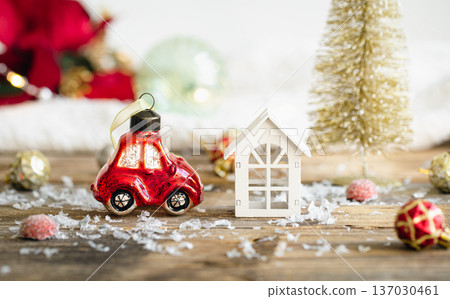 Christmas toy car and details of Christmas decor on a blurred background. Christmas toy car and details of Christmas decor on a blurred background. 137030461
