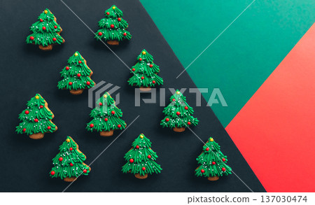 Christmas tree shaped gingerbread cookies covered with icing, flat lay. 137030474