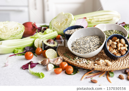 Close-up, a bowl of chia seeds and other healthy foods on the kitchen table. 137030556
