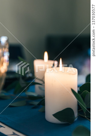 Close-up, burning candles on the table among the leaves. 137030577