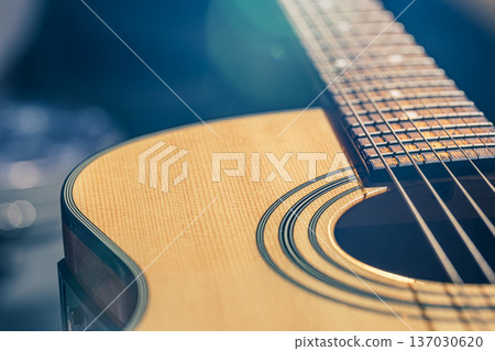 Acoustic guitar on a black background in the light of a spotlight. 137030620
