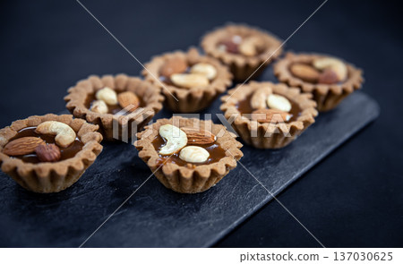 Close-up of cookies in the form of baskets with nut filling. 137030625