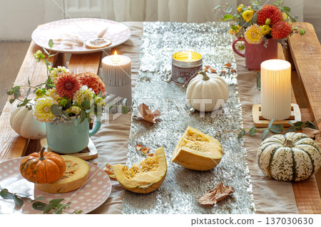 Festive table setting with pumpkins and chrysanthemum flowers. Festive table setting with pumpkins and chrysanthemum flowers. 137030630