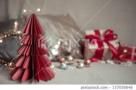 Close-up of a decorative cardboard Christmas tree on a blurred background. 137030646
