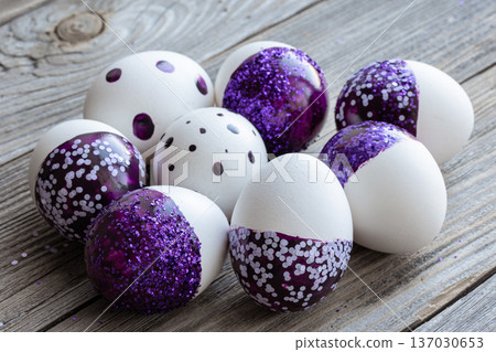 Close-up of Easter eggs decorated with purple sparkles. Close-up of Easter eggs decorated with purple sparkles. 137030653
