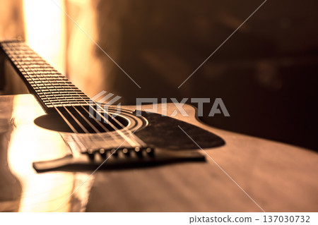 acoustic guitar close-up on a beautiful colored background 137030732