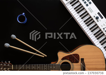 Musical background with guitar, piano, drum sticks and a cup of coffee. 137030738