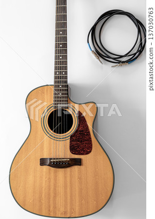 Acoustic guitar on a white background, top view, copy space. Acoustic guitar on a white background, top view, copy space. 137030763