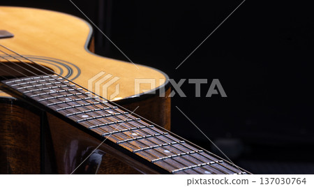 Part of acoustic guitar on black background copy space. 137030764