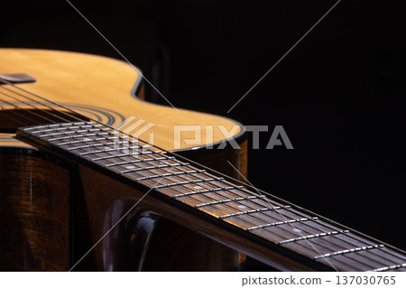 Part of acoustic guitar on black background copy space. 137030765