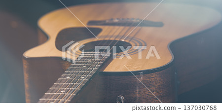 Close-up of a classical acoustic guitar on a black background. 137030768
