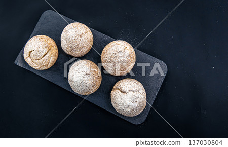 Appetizing Shu cakes on a black background. Appetizing Shu cakes on a black background. 137030804