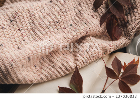 Autumn background with a knitted element, a cup of tea and autumn leaves. 137030838