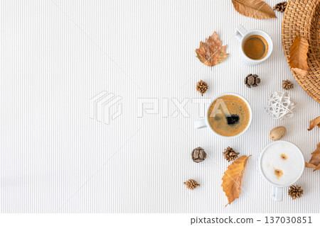 Autumn composition with cups of coffee and leaves on a white background. Autumn composition with cups of coffee and leaves on a white background. 137030851