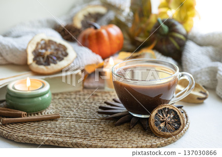 Autumn composition with a cup of tea, yourself and other decorative details. Autumn composition with a cup of tea, yourself and other decorative details. 137030866