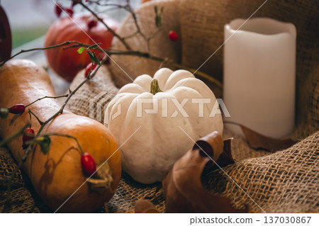Autumn composition with pumpkins on burlap close-up. 137030867