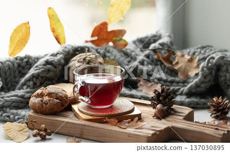 Autumn still life with a cup of tea, cookies and a knitted item. Autumn still life with a cup of tea, cookies and a knitted item. 137030895