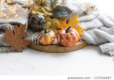 Autumn still life with pumpkins, leaves and knitted element. 137030897