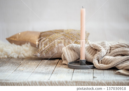 Background with a cozy knitted sweater and a candle. Background with a cozy knitted sweater and a candle. 137030918