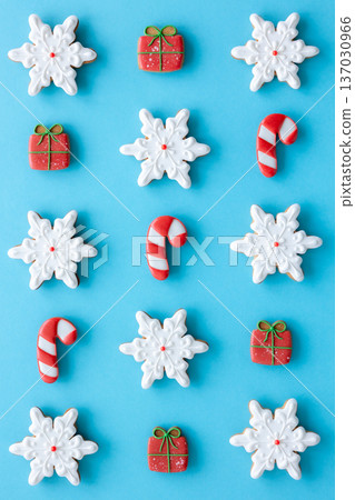 Beautiful Christmas glazed gingerbread cookies on a blue background, flat lay. 137030966