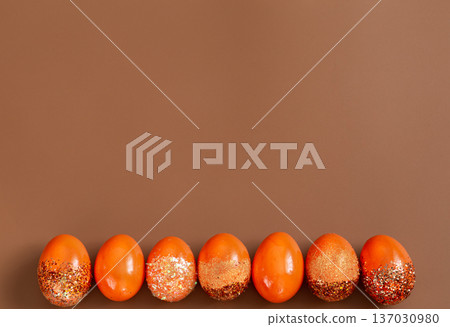 Beautiful Easter background with orange decorative eggs. 137030980