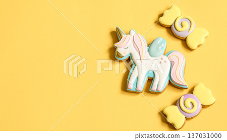 Colorful glazed gingerbread cookies on yellow background copy space. Colorful glazed gingerbread cookies on yellow background copy space. 137031000