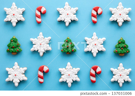 Beautiful handmade Christmas glazed gingerbread cookies on a blue background. 137031006