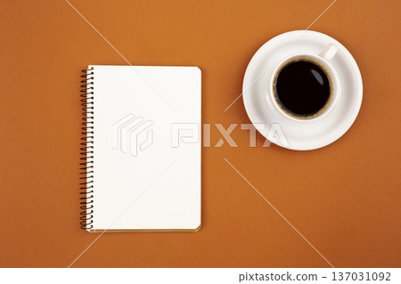 Blank notepad and coffee cup on a brown background, flat lay. Blank notepad and coffee cup on a brown background, flat lay. 137031092