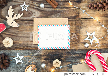 Blank paper, envelope and Christmas decor on wooden background, copy space. 137031100