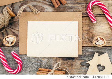 Blank paper, envelope and Christmas decor on wooden background, copy space. Blank paper, envelope and Christmas decor on wooden background, copy space. 137031102