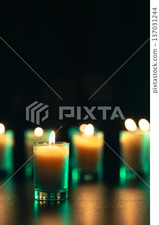 Burning candle on black background with backlight. Memorial Day. 137031244