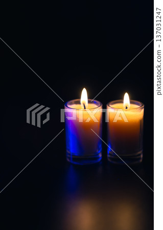 Burning candle on black background with backlight. Memorial Day. 137031247