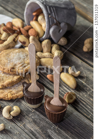 chocolate and nuts on wooden background chocolate and nuts on wooden background 137031319
