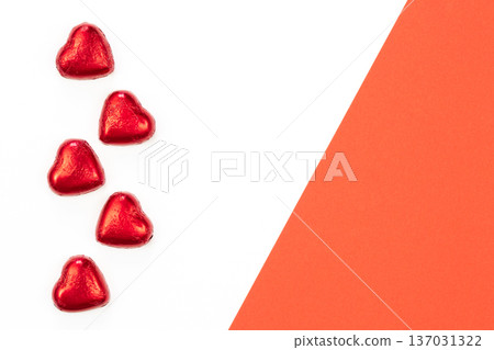 Chocolate sweets in the form of hearts on a white background, flat lay. Chocolate sweets in the form of hearts on a white background, flat lay. 137031322